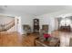 Open living room with hardwood floors, decorative chairs, and staircase access at 374 Queens Sw Dr, Concord, NC 28025