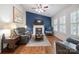 Comfortable living room featuring a fireplace, hardwood floors, and plush seating at 374 Queens Sw Dr, Concord, NC 28025