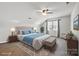 Bright main bedroom boasts a tufted headboard, ceiling fan, and a large window for natural light at 374 Queens Sw Dr, Concord, NC 28025