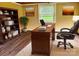 Well-lit office with hardwood floors, desk, chair, bookcase, and natural light at 374 Queens Sw Dr, Concord, NC 28025