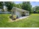Charming outbuilding featuring an open air section, storage, and serene landscaping at 374 Queens Sw Dr, Concord, NC 28025