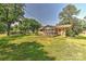 Exterior view of home showcasing spacious backyard, wooden deck, and lush green landscaping at 385 Gum Branch Rd, Charlotte, NC 28214