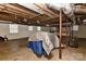 Large unfinished basement with exposed ceiling, concrete floor, and natural light at 385 Gum Branch Rd, Charlotte, NC 28214