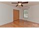 Neutral bedroom with hardwood floors, closet, and window allowing for ample natural light at 385 Gum Branch Rd, Charlotte, NC 28214