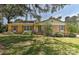 Charming brick home featuring a well-maintained lawn, mature trees, and a welcoming entrance at 385 Gum Branch Rd, Charlotte, NC 28214