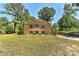 Charming exterior of home with brick facade, mature trees, and well-manicured lawn at 385 Gum Branch Rd, Charlotte, NC 28214