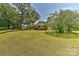 Well-maintained front yard with mature trees offering shade and curb appeal at 385 Gum Branch Rd, Charlotte, NC 28214
