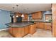Spacious kitchen with a large center island, wooden cabinets, and stainless steel appliances at 385 Gum Branch Rd, Charlotte, NC 28214