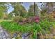 Beautiful landscaping with a variety of plants and flowers along a stone walkway at 385 Gum Branch Rd, Charlotte, NC 28214