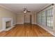 Elegant living room with hardwood floors, a fireplace, and large windows providing natural light at 385 Gum Branch Rd, Charlotte, NC 28214