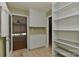 Functional mudroom includes storage cabinets, a door to the screened porch, and shelving for storage at 385 Gum Branch Rd, Charlotte, NC 28214