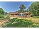 Rear exterior view showcasing attached garage, deck, and a well-maintained lawn at 385 Gum Branch Rd, Charlotte, NC 28214