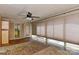 Bright sunroom featuring a ceiling fan, windows with blinds, and a view of the yard at 385 Gum Branch Rd, Charlotte, NC 28214