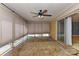 Enclosed sunroom with fan, tile floor, brick wall, and sliding glass doors at 385 Gum Branch Rd, Charlotte, NC 28214