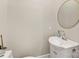 A stylish powder room features a round mirror and an elegant white sink at 4315 Hartis Grove Church Rd, Indian Trail, NC 28079