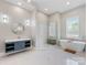 Bright bathroom showcases a modern tub, glass shower, and blue vanity at 4315 Hartis Grove Church Rd, Indian Trail, NC 28079