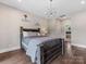 Bedroom with hardwood floors and a view to a modern lighting fixture at 4315 Hartis Grove Church Rd, Indian Trail, NC 28079