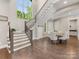 Grand foyer featuring a staircase, hardwood floors, and a dining area with a large window at 4315 Hartis Grove Church Rd, Indian Trail, NC 28079