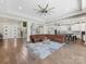 Spacious open-concept living area features hardwood floors, a large fan, and easy access to the kitchen and foyer at 4315 Hartis Grove Church Rd, Indian Trail, NC 28079