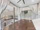 A loft with hardwood floors, glass railings and doors, and a chandelier at 4315 Hartis Grove Church Rd, Indian Trail, NC 28079