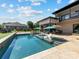 Gorgeous backyard featuring a pool, lounge chairs, an outdoor kitchen, and a beautifully landscaped lawn at 4315 Hartis Grove Church Rd, Indian Trail, NC 28079