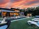 Beautiful backyard featuring a swimming pool, patio, outdoor kitchen, and lush landscaping, perfect for outdoor living at 4315 Hartis Grove Church Rd, Indian Trail, NC 28079
