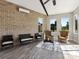 Relaxing sunroom featuring brick walls, comfortable seating, and natural light at 4315 Hartis Grove Church Rd, Indian Trail, NC 28079