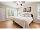 Cozy bedroom featuring hardwood floors, natural light, and a ceiling fan at 4570 Chanel Ct, Concord, NC 28025