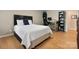 Cozy bedroom with hardwood floors, a comfortable bed, workspace, and natural light at 4570 Chanel Ct, Concord, NC 28025