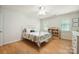 Bright bedroom featuring hardwood floors, ceiling fan, and large window for a serene space at 4570 Chanel Ct, Concord, NC 28025