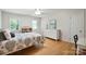 Bright bedroom featuring hardwood floors, large window, and white dresser for a serene space at 4570 Chanel Ct, Concord, NC 28025