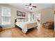Spacious bedroom with hardwood floors and ample natural light from multiple windows at 4570 Chanel Ct, Concord, NC 28025
