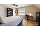 Bright bedroom featuring a ceiling fan, large window, bookcase and desk for a functional and comfortable space at 4570 Chanel Ct, Concord, NC 28025
