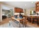 Bright dining area featuring hardwood floors, an open layout, and a breakfast bar adjacent to the well-equipped kitchen at 4570 Chanel Ct, Concord, NC 28025