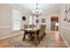 Inviting dining room featuring a rustic wooden table, neutral walls, and natural lighting at 4570 Chanel Ct, Concord, NC 28025