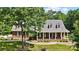 Charming brick home with a welcoming front porch, beautiful landscaping, and mature trees on a well-manicured lawn at 4570 Chanel Ct, Concord, NC 28025