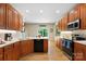 Well-lit kitchen with wooden cabinets, stainless steel appliances, and quartz countertops offering a view to the backyard at 4570 Chanel Ct, Concord, NC 28025