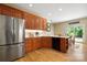 Well-lit kitchen featuring stainless steel appliances, custom cabinets, and hardwood floors at 4570 Chanel Ct, Concord, NC 28025