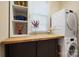 Functional laundry area with storage shelving, wooden countertop and modern washer/dryer units at 4570 Chanel Ct, Concord, NC 28025