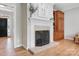 Living room with tiled fireplace, built-in shelving, and hardwood floors at 4570 Chanel Ct, Concord, NC 28025