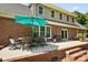 Covered brick patio with an outdoor dining set and grill at 4570 Chanel Ct, Concord, NC 28025