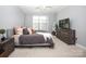Cozy bedroom featuring a ceiling fan, dresser, television, and a large window for natural light at 5063 Gribble Ln, Lancaster, SC 29720