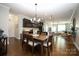 Open dining area features hardwood floors and a modern chandelier adjacent to the kitchen at 5063 Gribble Ln, Lancaster, SC 29720