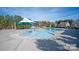 Community pool featuring a splash area under a light blue and tan shade structure with houses and trees in the background at 5063 Gribble Ln, Lancaster, SC 29720