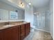 Bathroom with double vanity, large mirror and glass shower at 5075 Meanna Dr, Clover, SC 29710