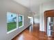 Dining room with hardwood floors and large windows that view the green backyard at 5075 Meanna Dr, Clover, SC 29710