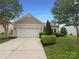 Charming single-story home with a well-manicured front yard and attached two-car garage at 5075 Meanna Dr, Clover, SC 29710