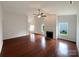 Spacious living room featuring hardwood floors, fireplace, ceiling fan, and lots of natural light at 5075 Meanna Dr, Clover, SC 29710