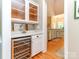 Stylish bar area with a wine cooler, storage cabinets, and countertop space, perfect for entertaining at 5321 Kathryn Blair Ln, Charlotte, NC 28226