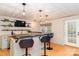 Stylish bar area includes seating, a sink, shelving and modern lighting at 5321 Kathryn Blair Ln, Charlotte, NC 28226